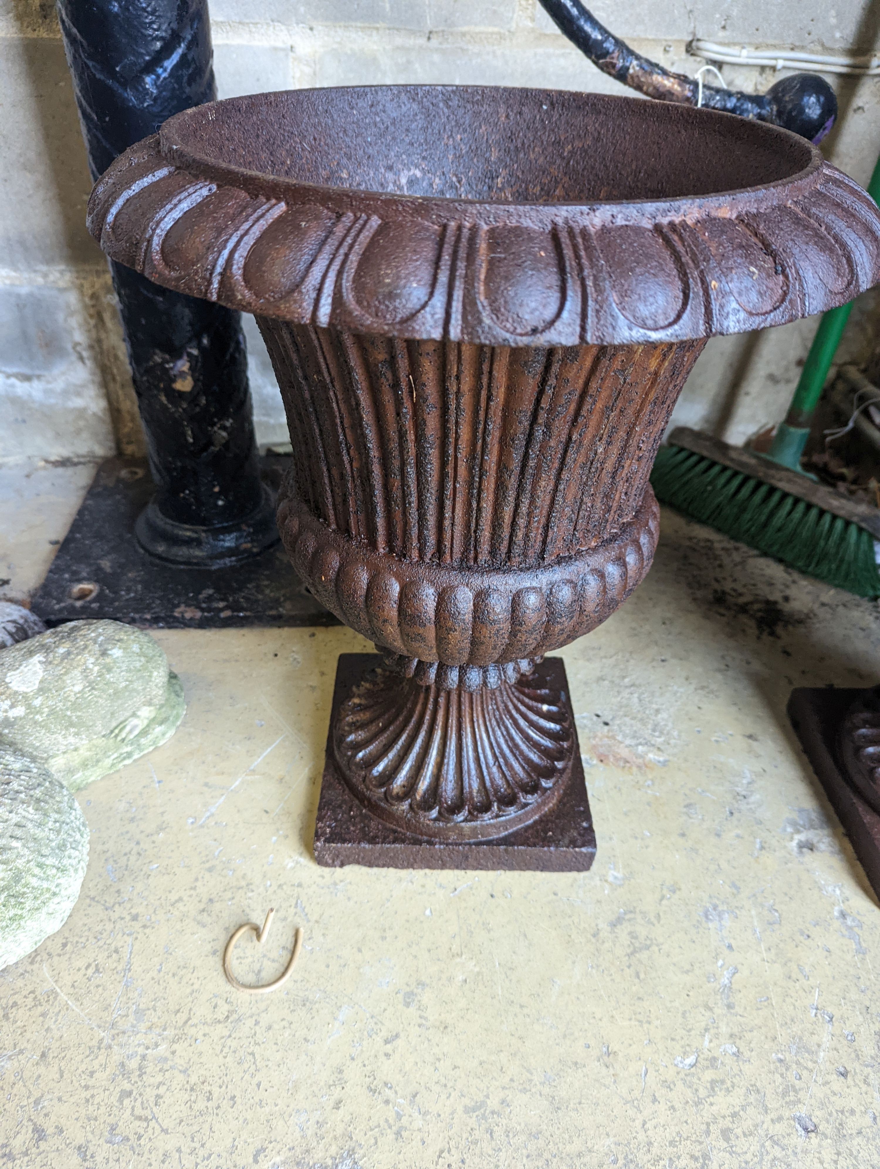 A pair of Victorian circular cast iron campana garden urns, diameter 38cm, height 46cm